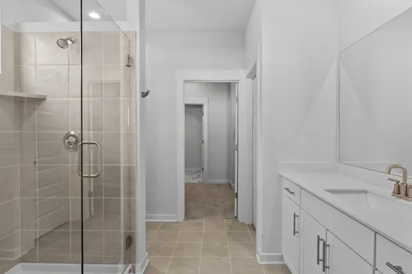a kitchen with white cabinets and appliances