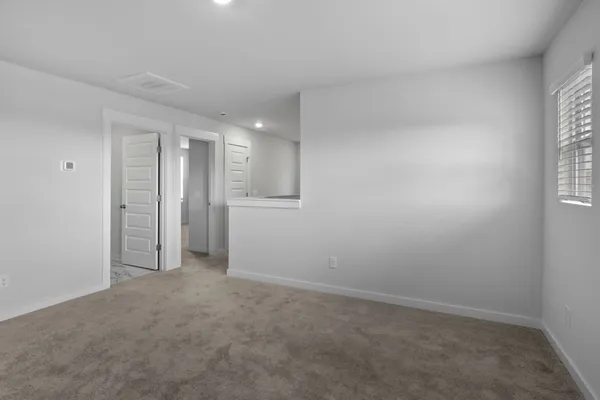 an empty room with windows and closet