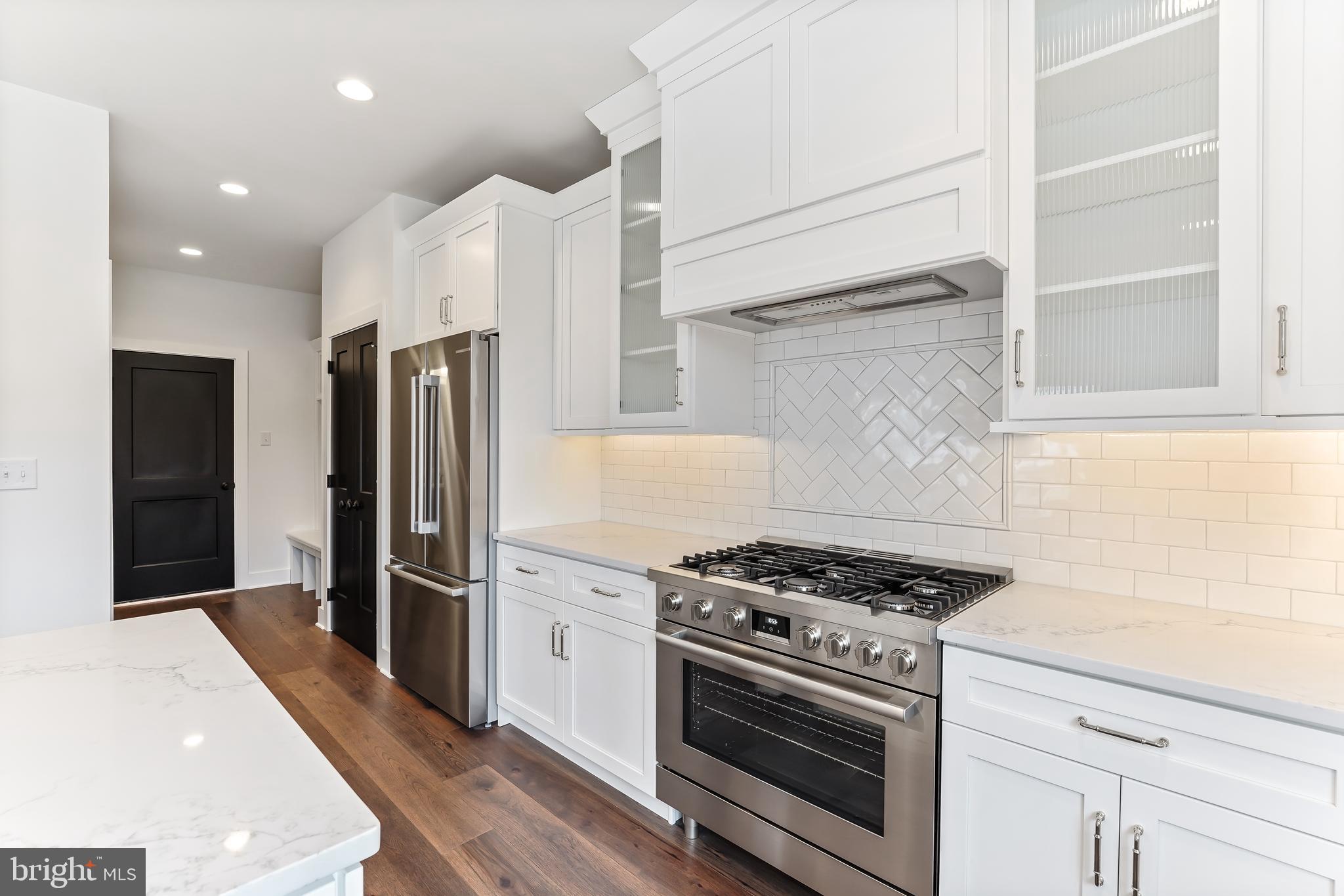a kitchen with stainless steel appliances a refrigerator a stove and cabinets