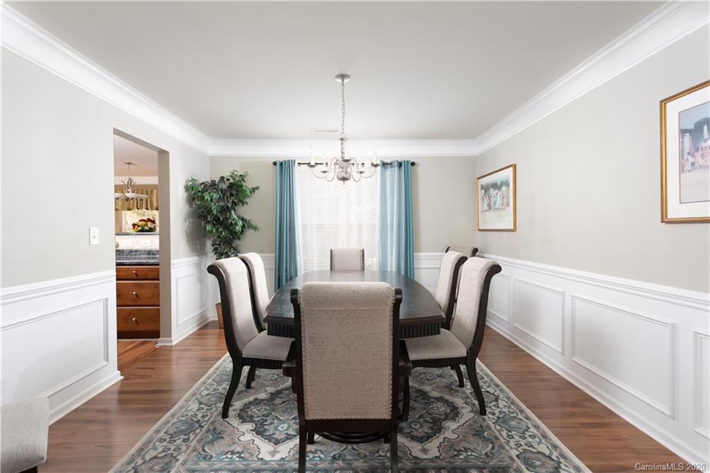 1703 Newland Road, Unit 124 Denver, NC 28037 - Photo 3 of 11 a dining room with furniture a chandelier and wooden floor