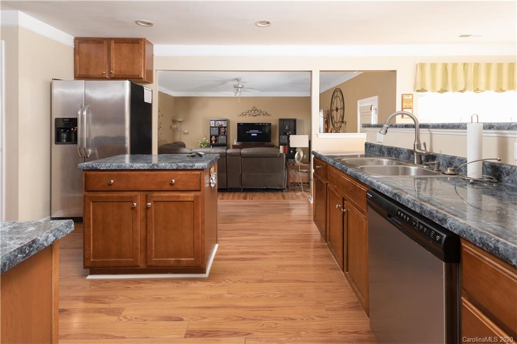 1703 Newland Road, Unit 124 Denver, NC 28037 - Photo 5 of 11 a kitchen with stainless steel appliances granite countertop a stove a sink and a refrigerator