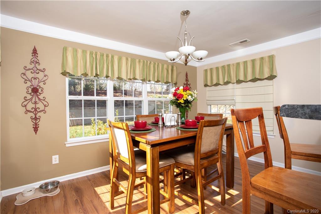 1703 Newland Road, Unit 124 Denver, NC 28037 - Photo 6 of 11 a view of a dining room with furniture window and wooden floor