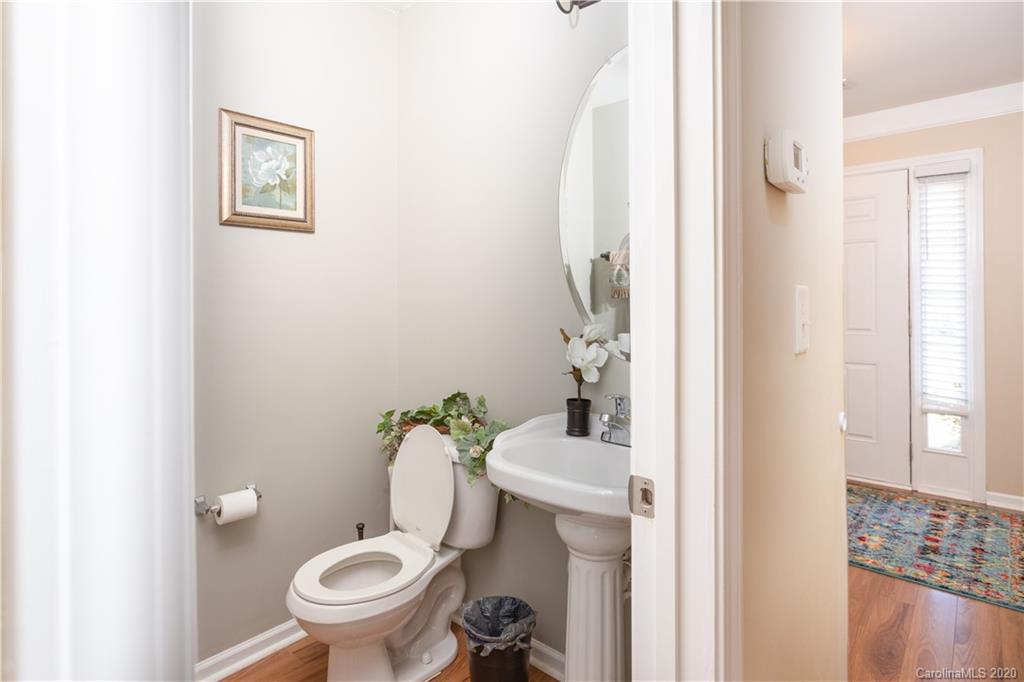1703 Newland Road, Unit 124 Denver, NC 28037 - Photo 7 of 11 a white toilet sitting next to a bathroom sink