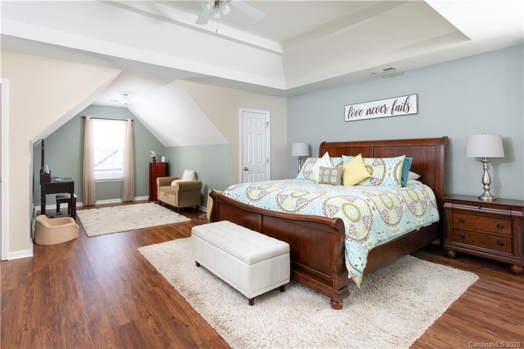 1703 Newland Road, Unit 124 Denver, NC 28037 - Photo 8 of 11 a bedroom with a bed and wooden floor