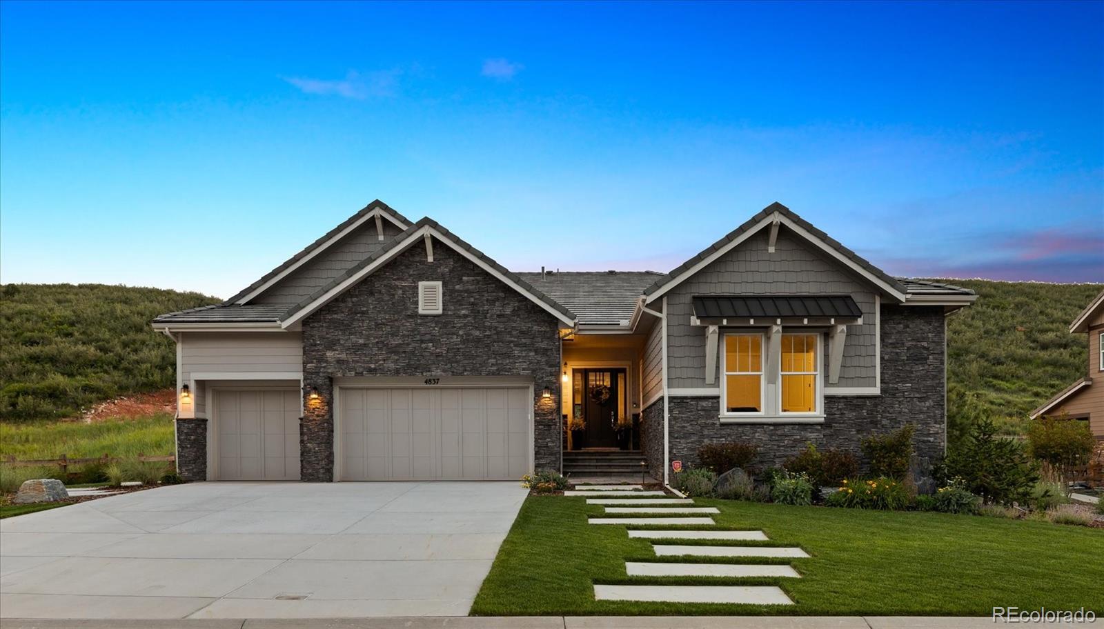 4837 Hogback Ridge Road Morrison, CO 80465 - Photo 1 of 40 a front view of a house with a yard