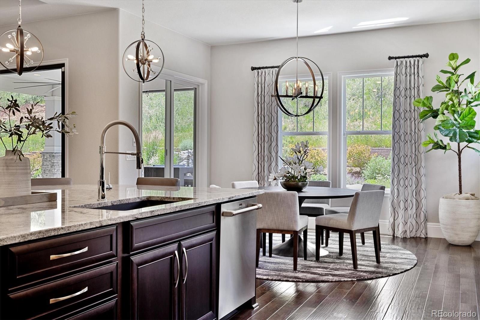 4837 Hogback Ridge Road Morrison, CO 80465 - Photo 13 of 40 a kitchen with a table chairs and a window