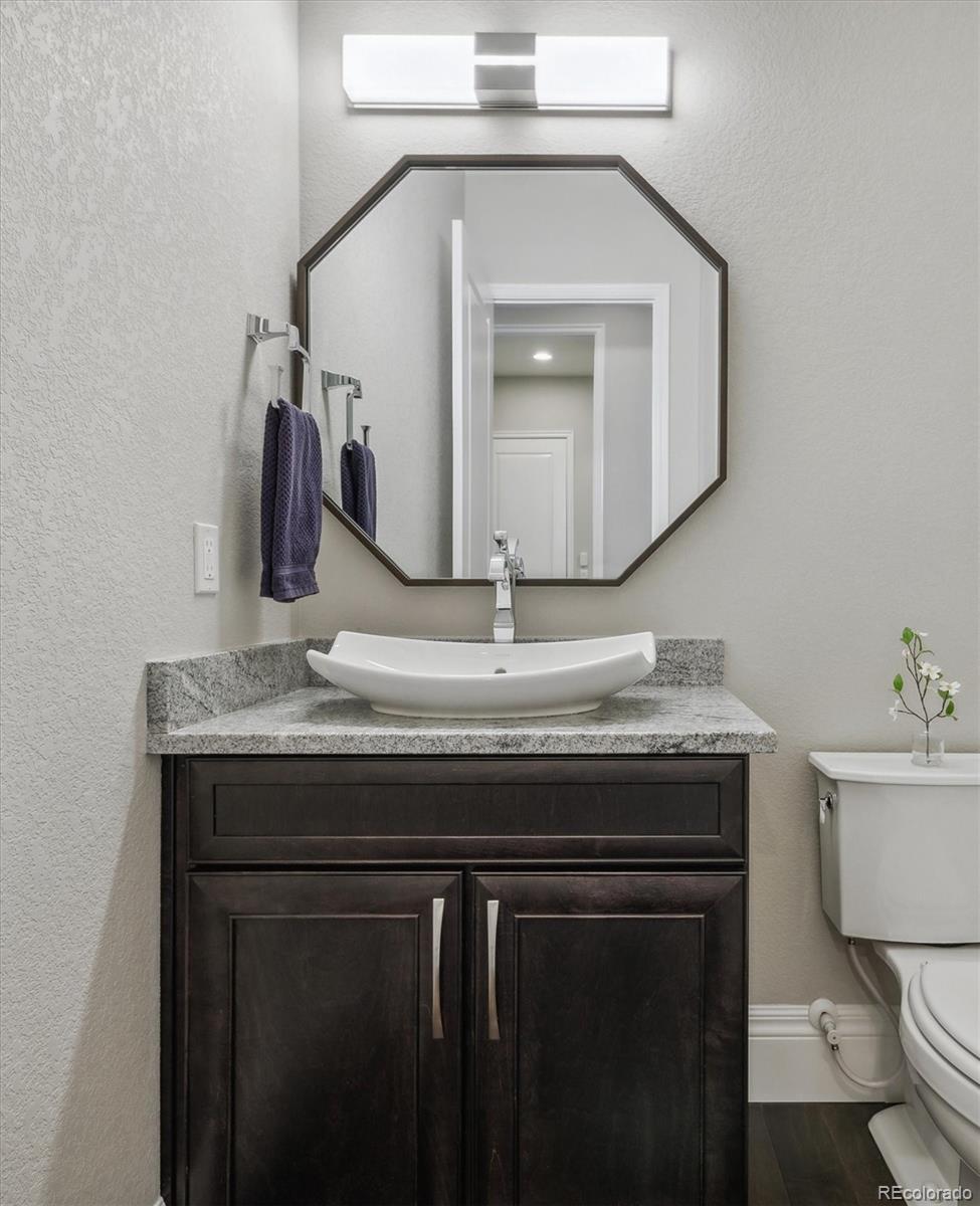 4837 Hogback Ridge Road Morrison, CO 80465 - Photo 19 of 40 a bathroom with a toilet a sink and a mirror