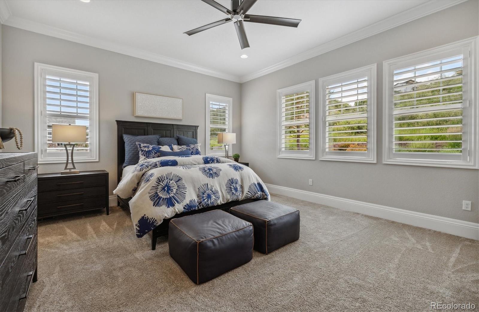4837 Hogback Ridge Road Morrison, CO 80465 - Photo 21 of 40 a bedroom with a bed and window