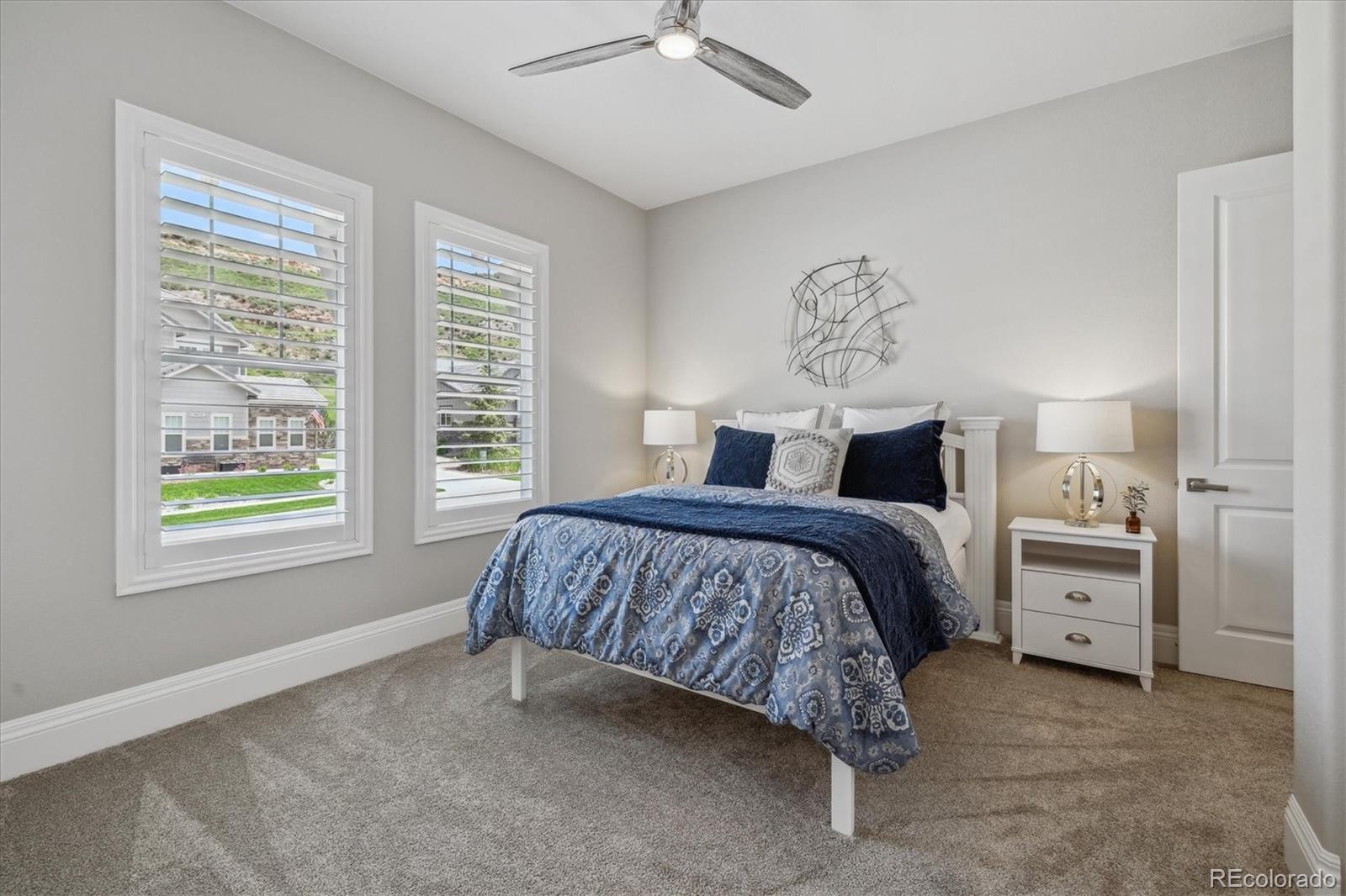 4837 Hogback Ridge Road Morrison, CO 80465 - Photo 24 of 40 a bedroom with bed and window