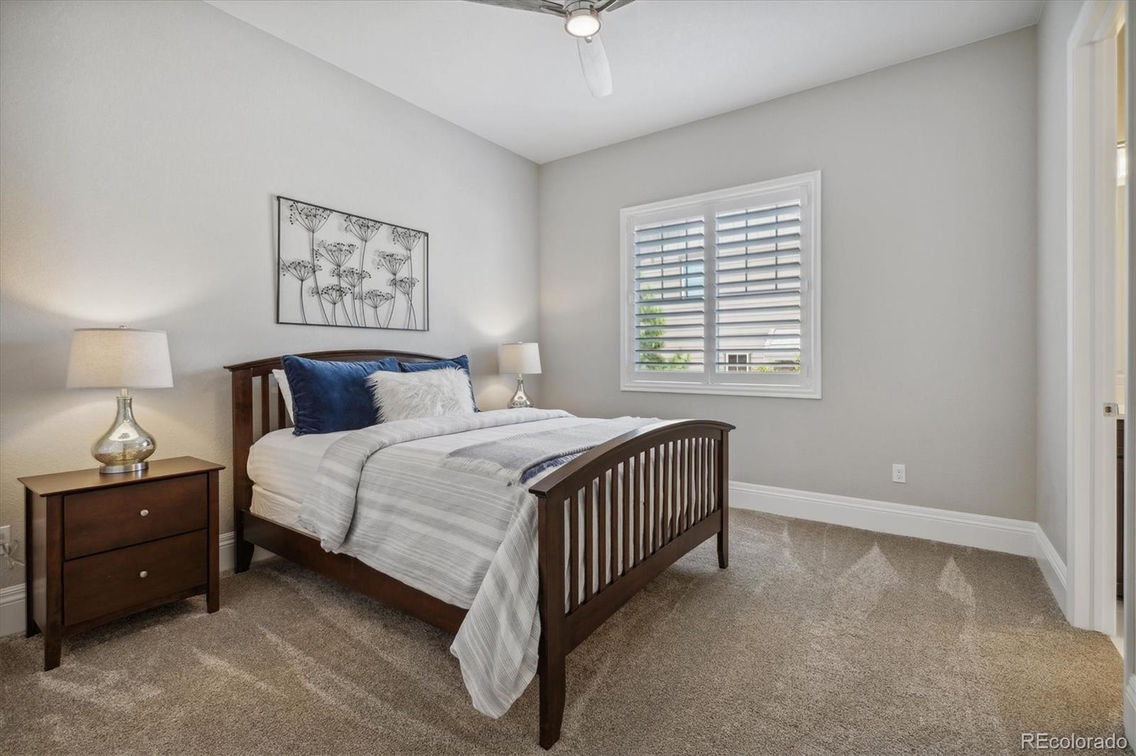 4837 Hogback Ridge Road Morrison, CO 80465 - Photo 25 of 40 a bedroom with a bed and a night stand