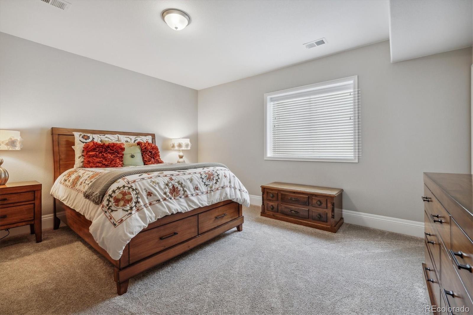4837 Hogback Ridge Road Morrison, CO 80465 - Photo 29 of 40 a bedroom with a bed and a couch