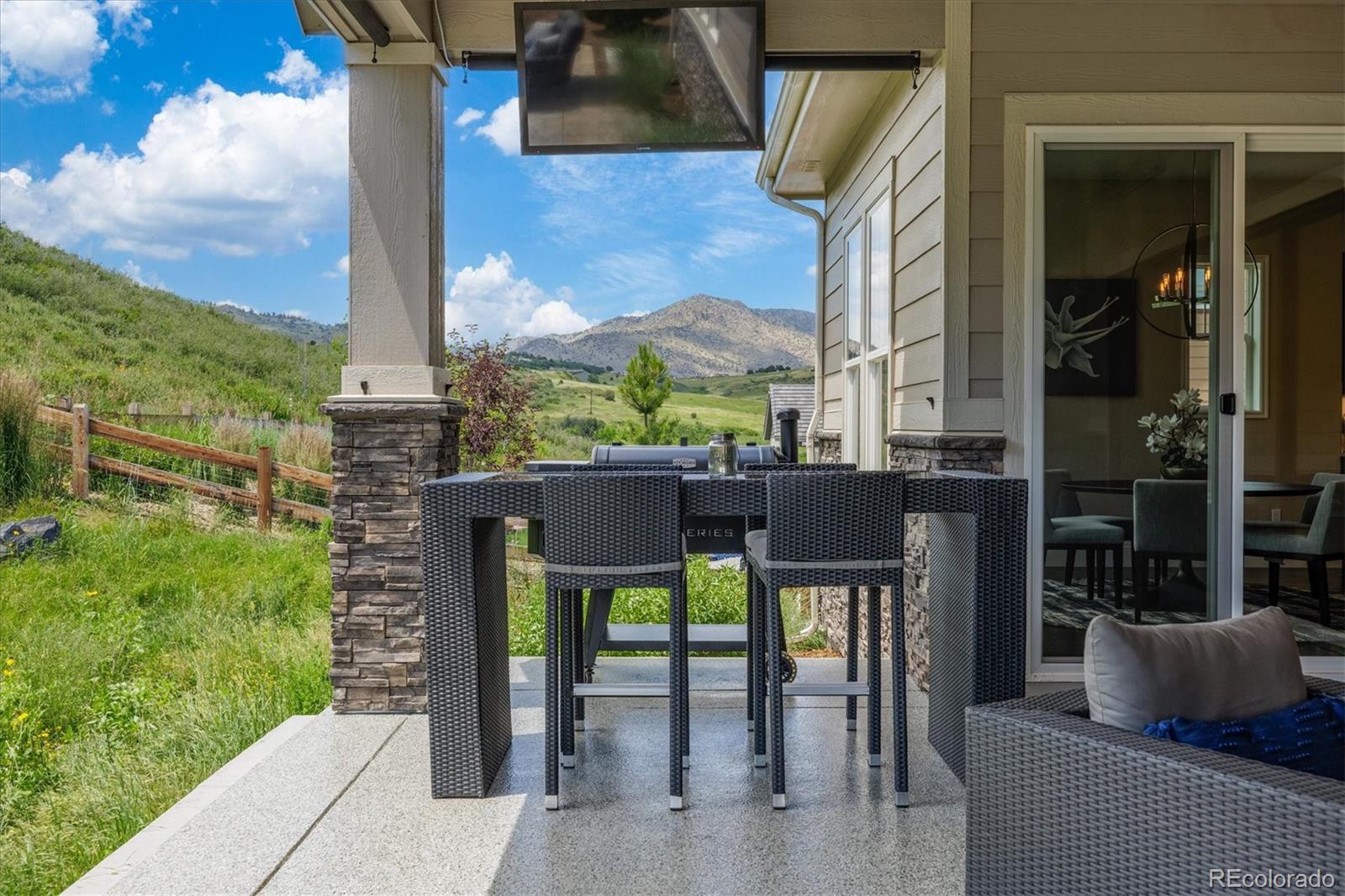 4837 Hogback Ridge Road Morrison, CO 80465 - Photo 36 of 40 a view of a patio with table and chairs and potted plants