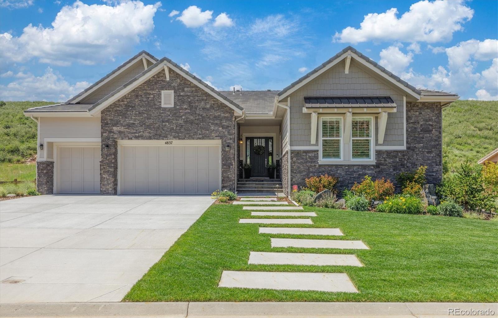 4837 Hogback Ridge Road Morrison, CO 80465 - Photo 40 of 40 a front view of a house with a yard