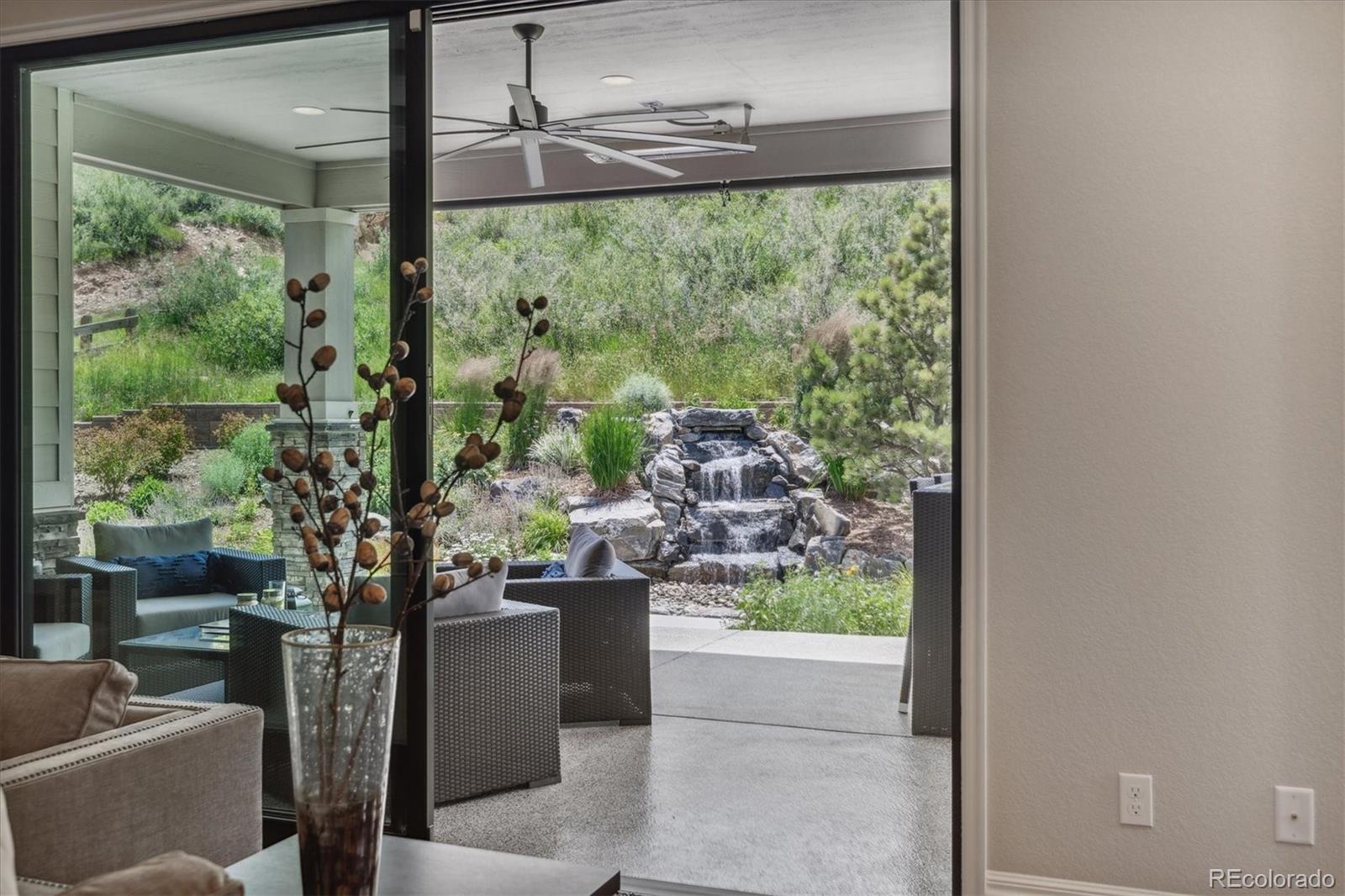 4837 Hogback Ridge Road Morrison, CO 80465 - Photo 6 of 40 a living room view with a floor to ceiling window and tree
