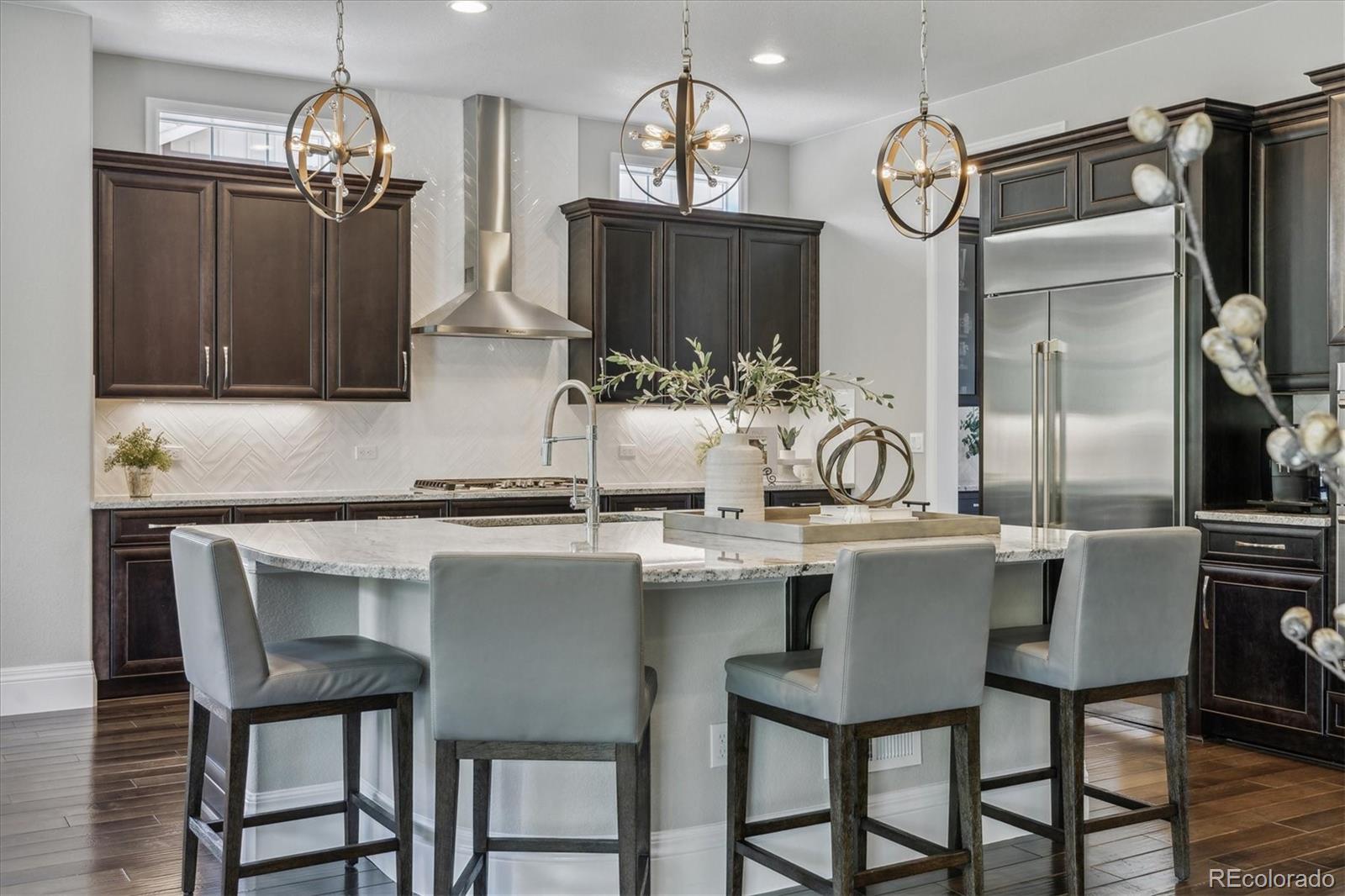 4837 Hogback Ridge Road Morrison, CO 80465 - Photo 9 of 40 a kitchen with a table chairs refrigerator and cabinets