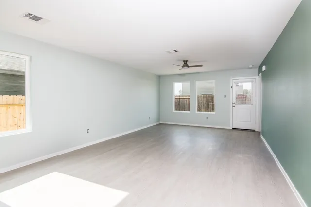 wooden floor in an empty room with a window