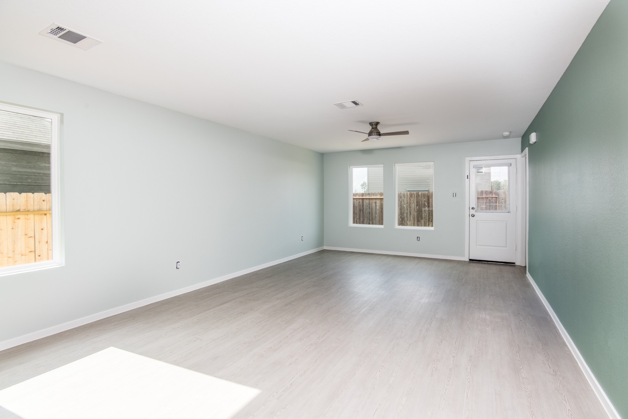 14852 North Ascot Bnd Circle Conroe, TX 77306 - Photo 9 of 21 wooden floor in an empty room with a window
