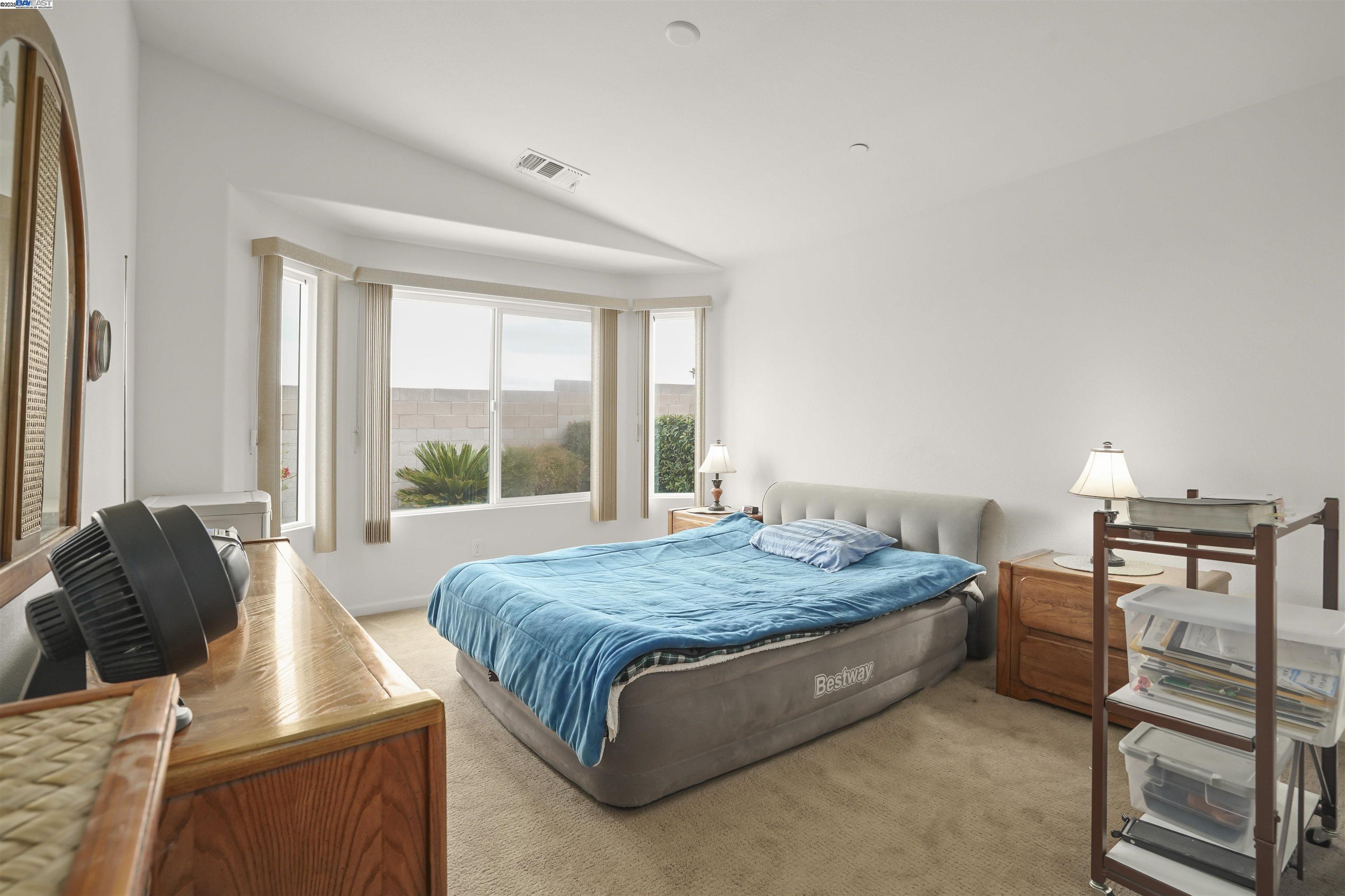 422 Saddle Rock Lane Rio Vista, CA 94571 - Photo 13 of 40 a bed sitting in a bedroom next to a window