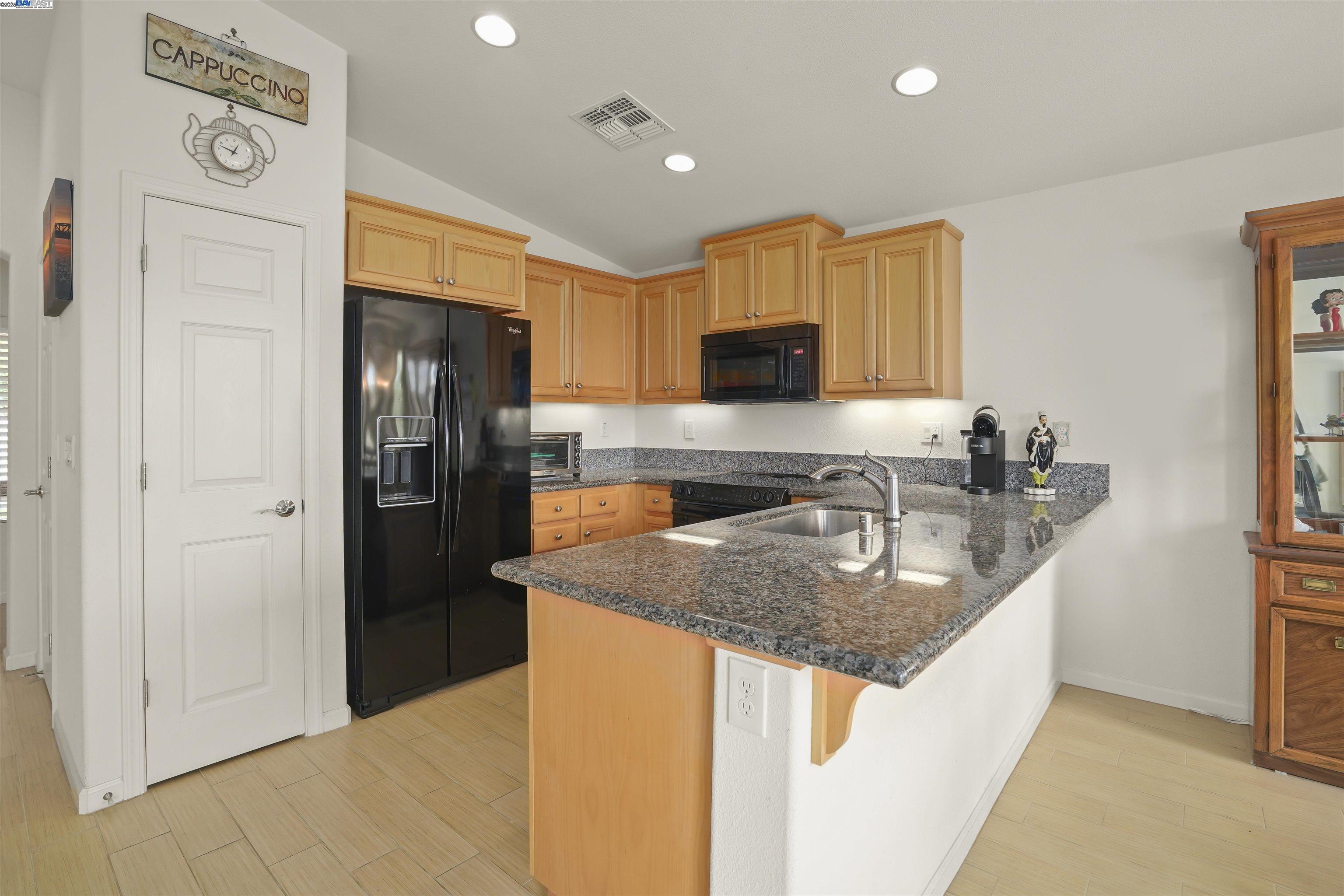 422 Saddle Rock Lane Rio Vista, CA 94571 - Photo 8 of 40 a kitchen with stainless steel appliances granite countertop a sink a refrigerator and a stove