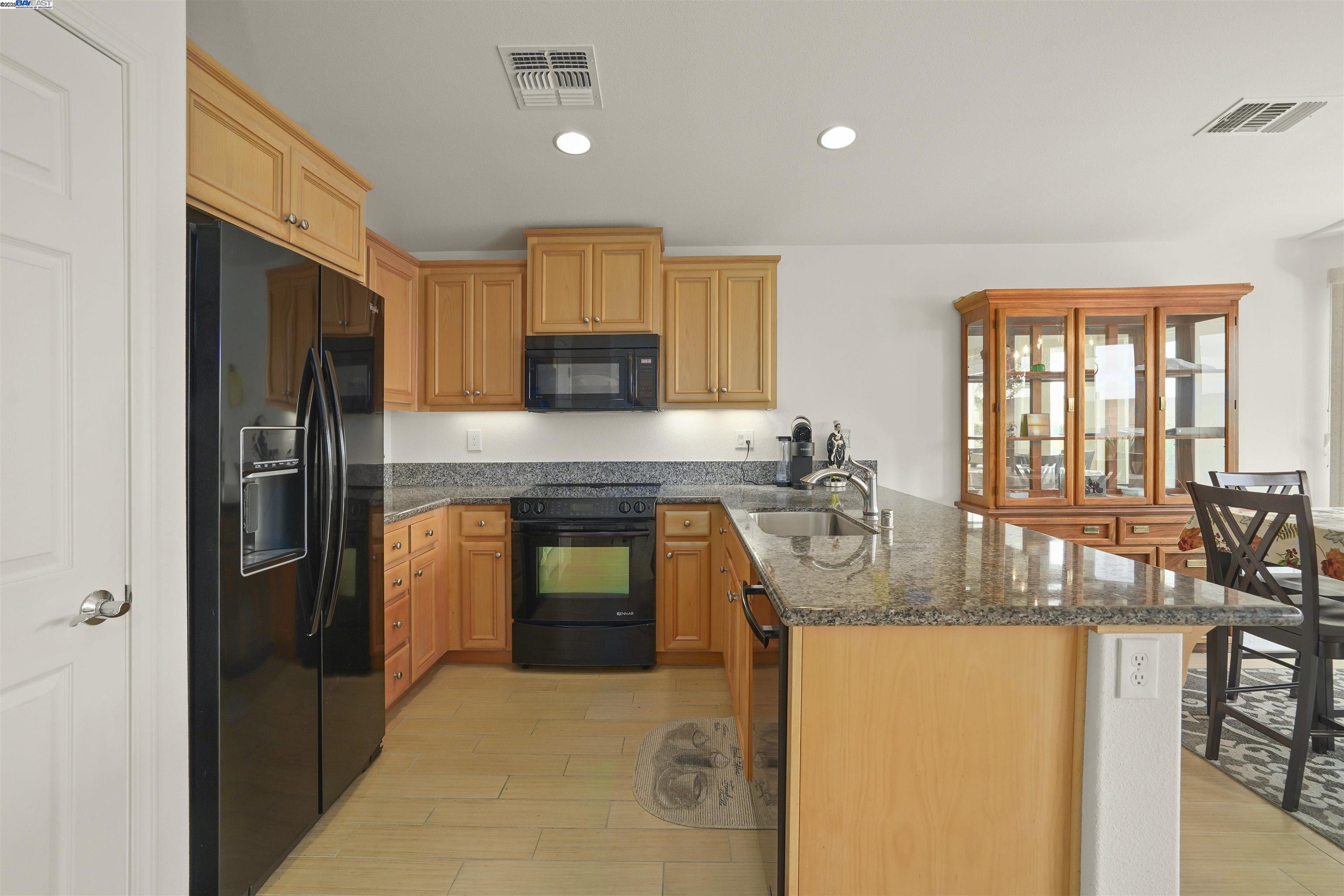 422 Saddle Rock Lane Rio Vista, CA 94571 - Photo 9 of 40 a kitchen with stainless steel appliances granite countertop a sink and a refrigerator