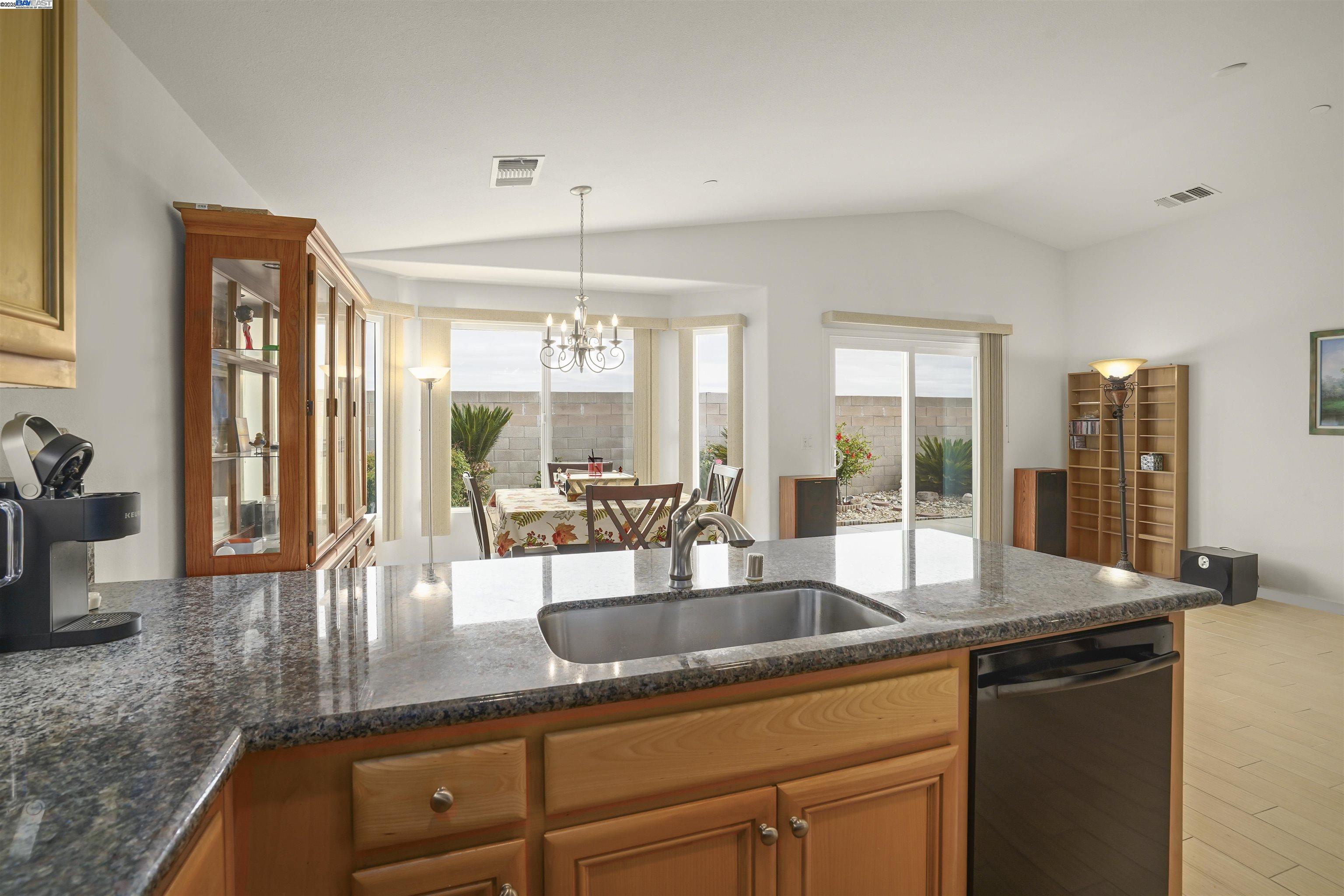 422 Saddle Rock Lane Rio Vista, CA 94571 - Photo 10 of 40 a kitchen with granite countertop a sink and a counter top space
