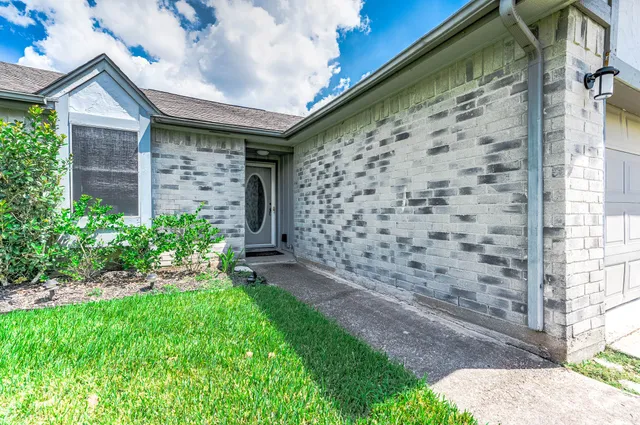 a brick house with a yard