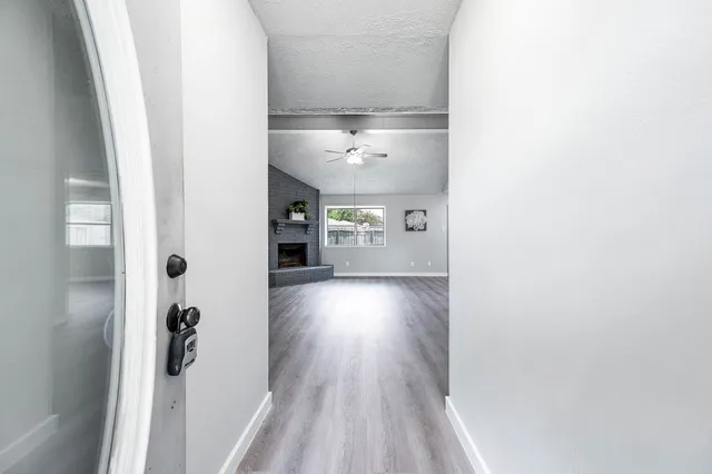 a view of a hallway view with wooden floor and staircase