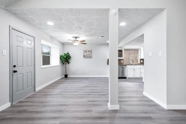 a kitchen with stainless steel appliances kitchen island a refrigerator sink and microwave