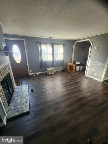 a kitchen with a sink and wooden floor