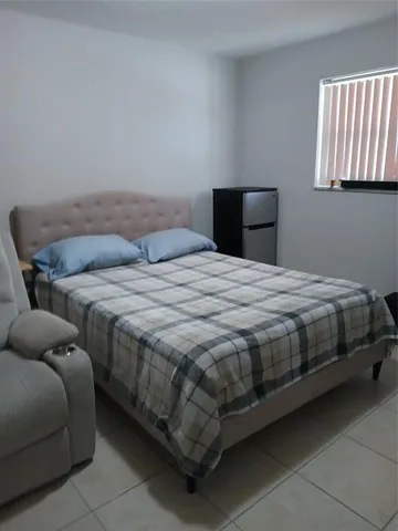 a bathroom with a toilet sink and shower