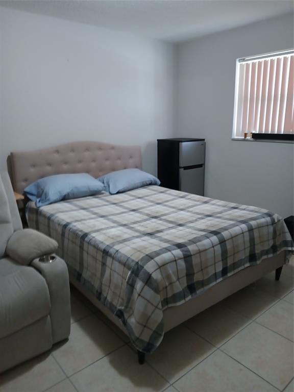 55 Southeast 14th Street, Unit 1120 Boca Raton, FL 33432 - Photo 12 of 24 a bedroom with bed and window