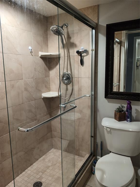 55 Southeast 14th Street, Unit 1120 Boca Raton, FL 33432 - Photo 21 of 24 a bathroom with a toilet and a shower