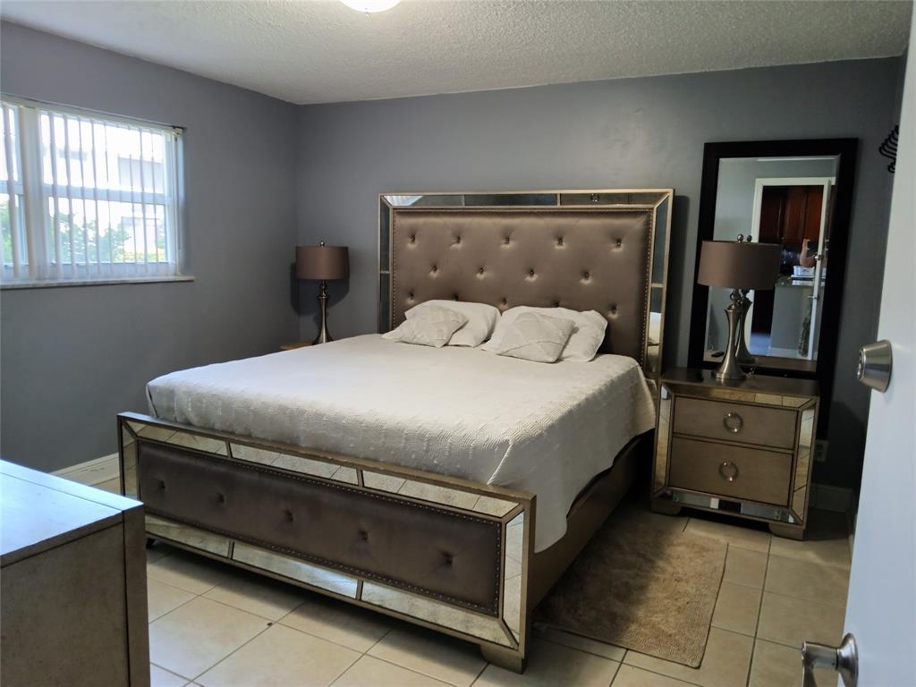 55 Southeast 14th Street, Unit 1120 Boca Raton, FL 33432 - Photo 24 of 24 a bedroom with a bed and a window