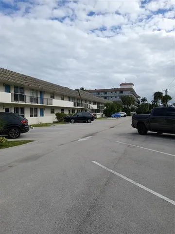 a view of house with swimming pool and a yard