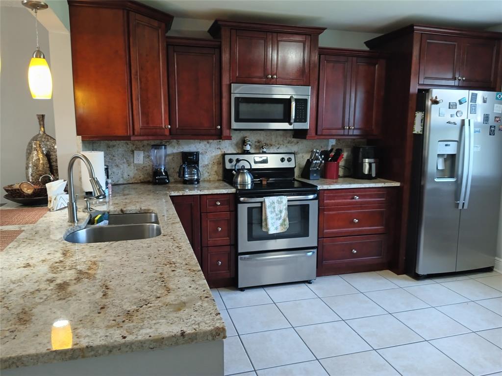 55 Southeast 14th Street, Unit 1120 Boca Raton, FL 33432 - Photo 3 of 24 a kitchen with stainless steel appliances granite countertop a refrigerator stove a sink and dishwasher
