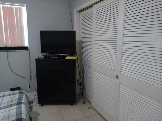 a bedroom with bed and window