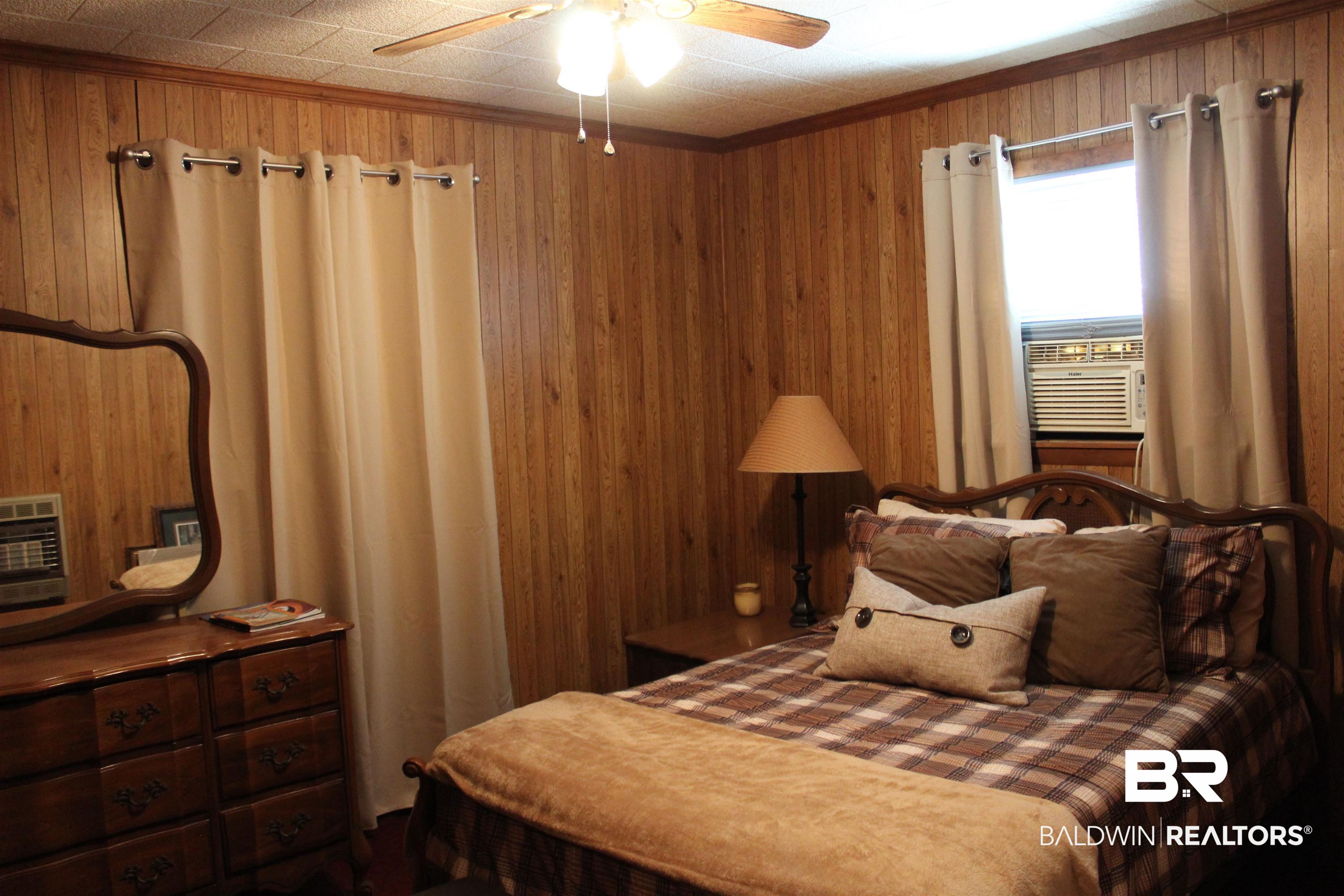 6447 Henderson Road Lowndesboro, AL 36752 - Photo 15 of 22 Bedroom with ceiling fan and cooling unit