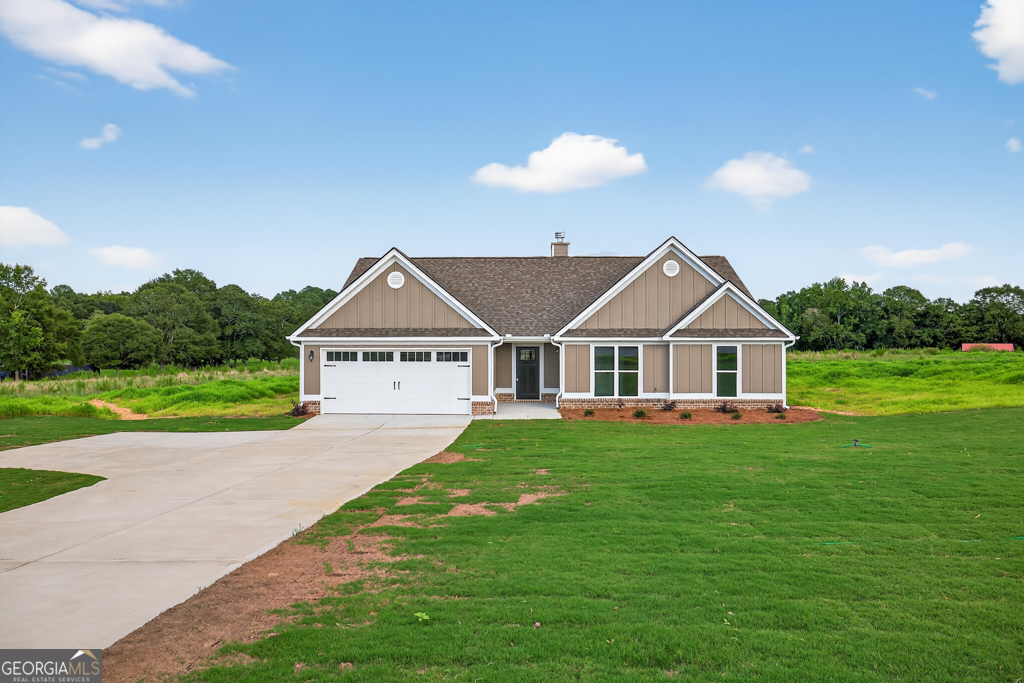 a view of a house with a yard and potted plants