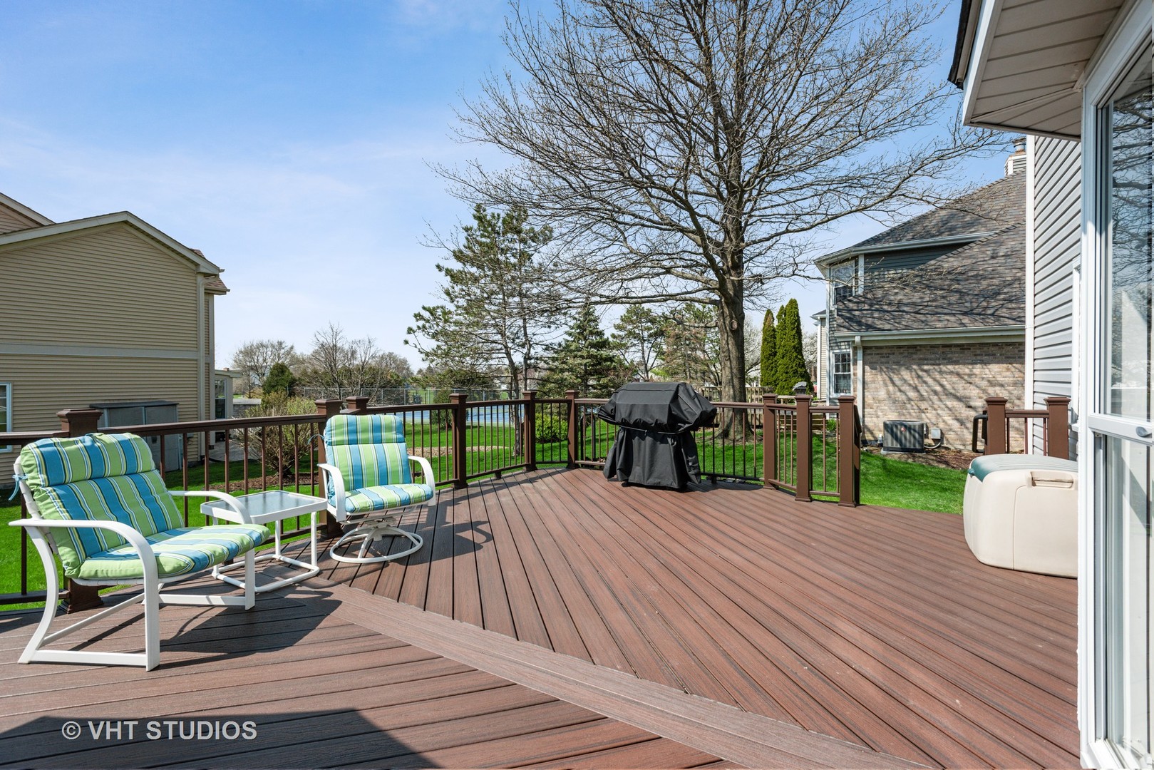 4338 Hatch Lane Lisle, IL 60532 - Photo 30 of 35 a view of a deck with table and chairs couches and potted plants with wooden floor and fence