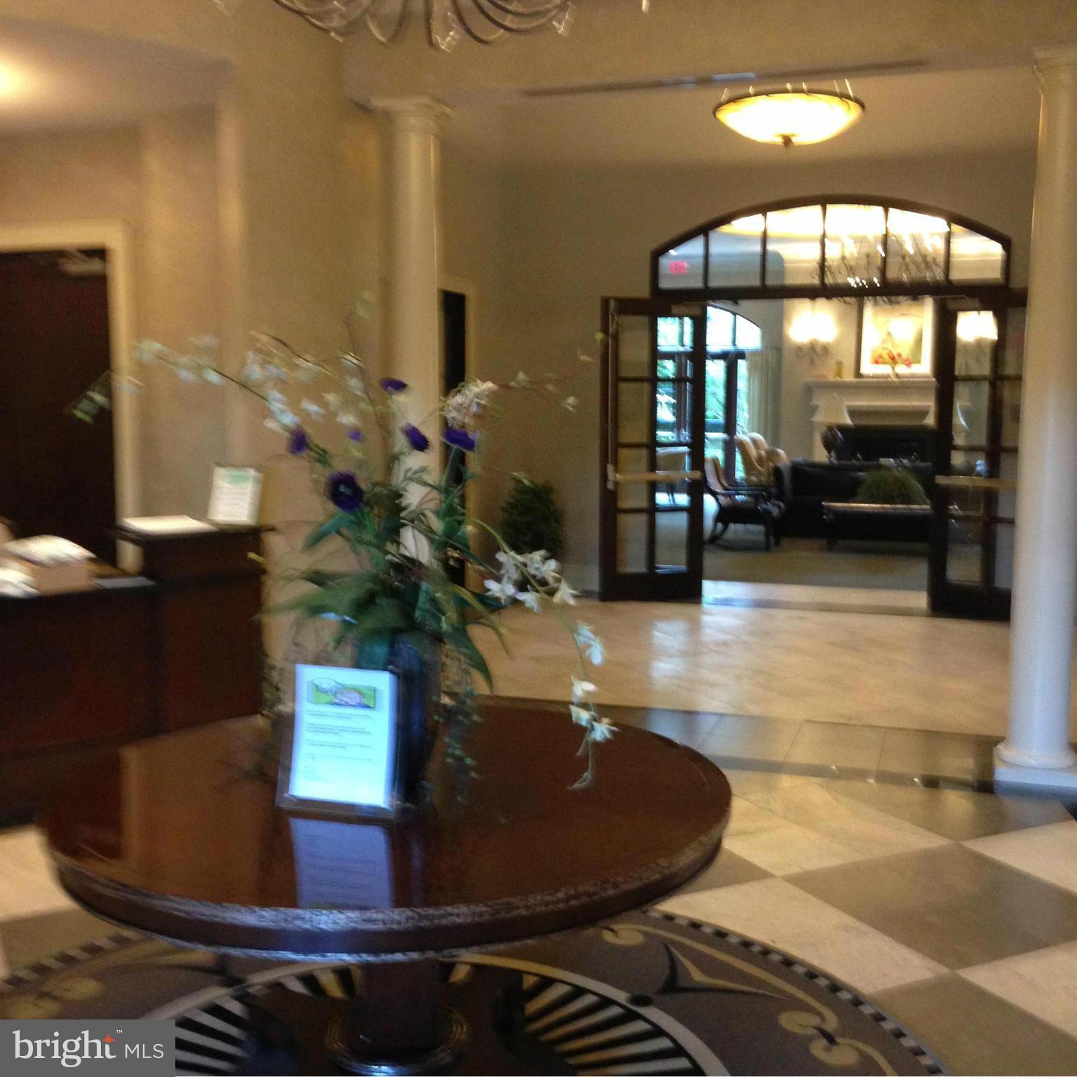 11710 Old Georgetown Road, Unit 1213 North Bethesda, MD 20852 - Photo 3 of 15 a lobby with furniture and floor to ceiling window