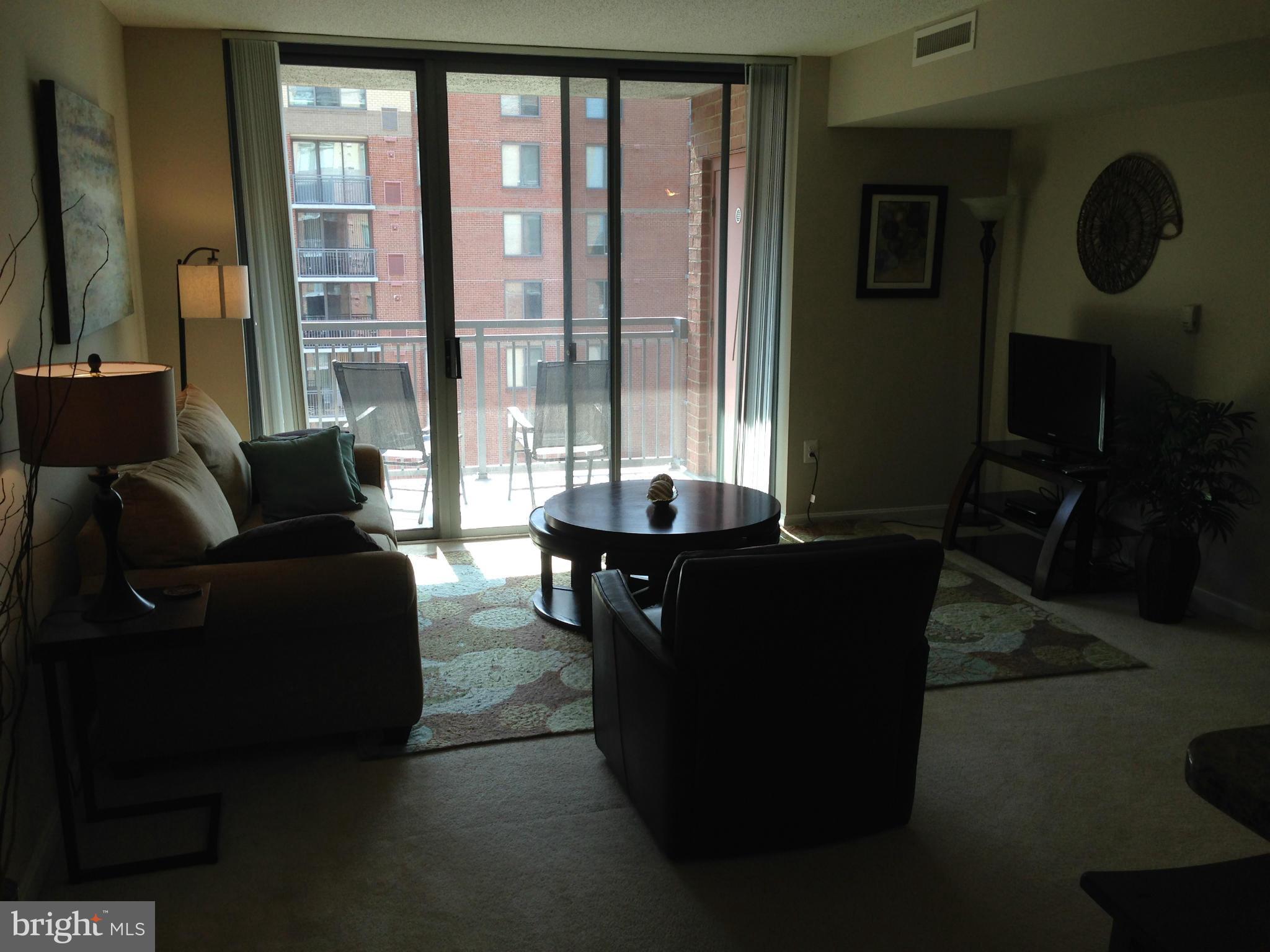 11710 Old Georgetown Road, Unit 1213 North Bethesda, MD 20852 - Photo 8 of 15 a living room with furniture and a large window