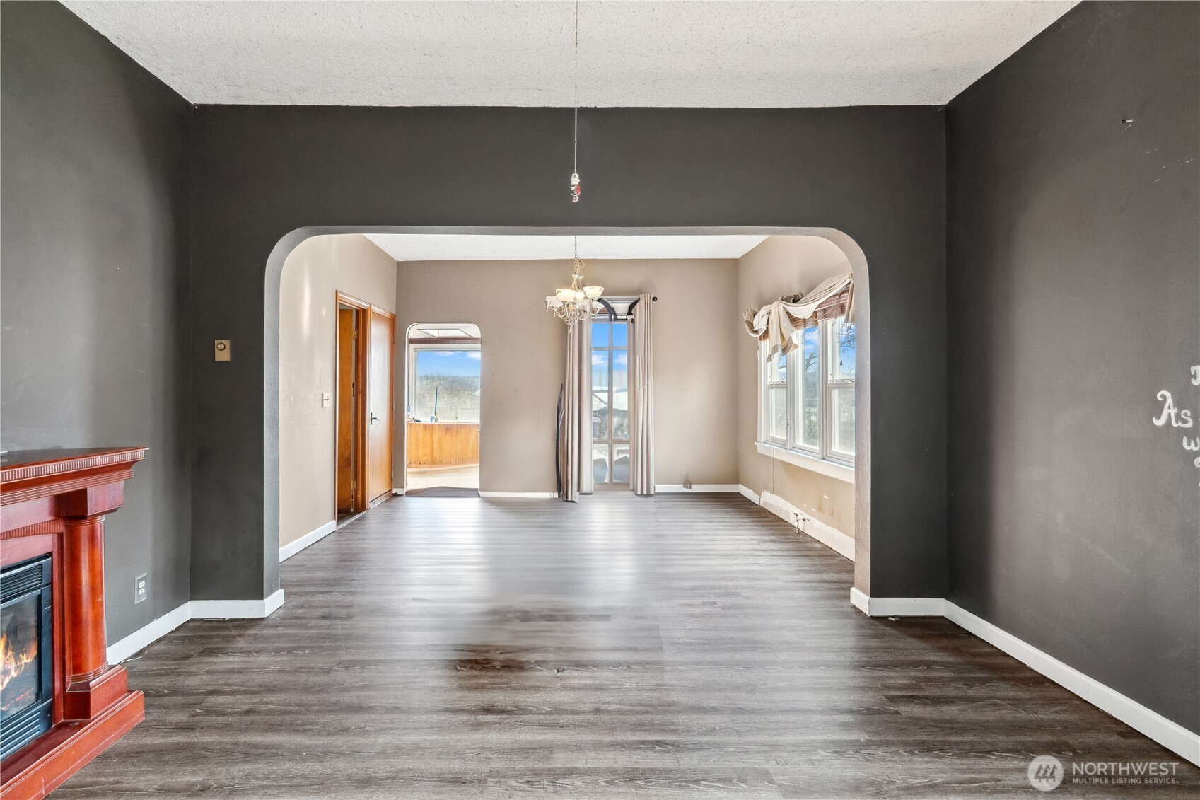 2113 East Grand Avenue Everett, WA 98201 - Photo 14 of 22 a view of a hallway with wooden floor and a fireplace