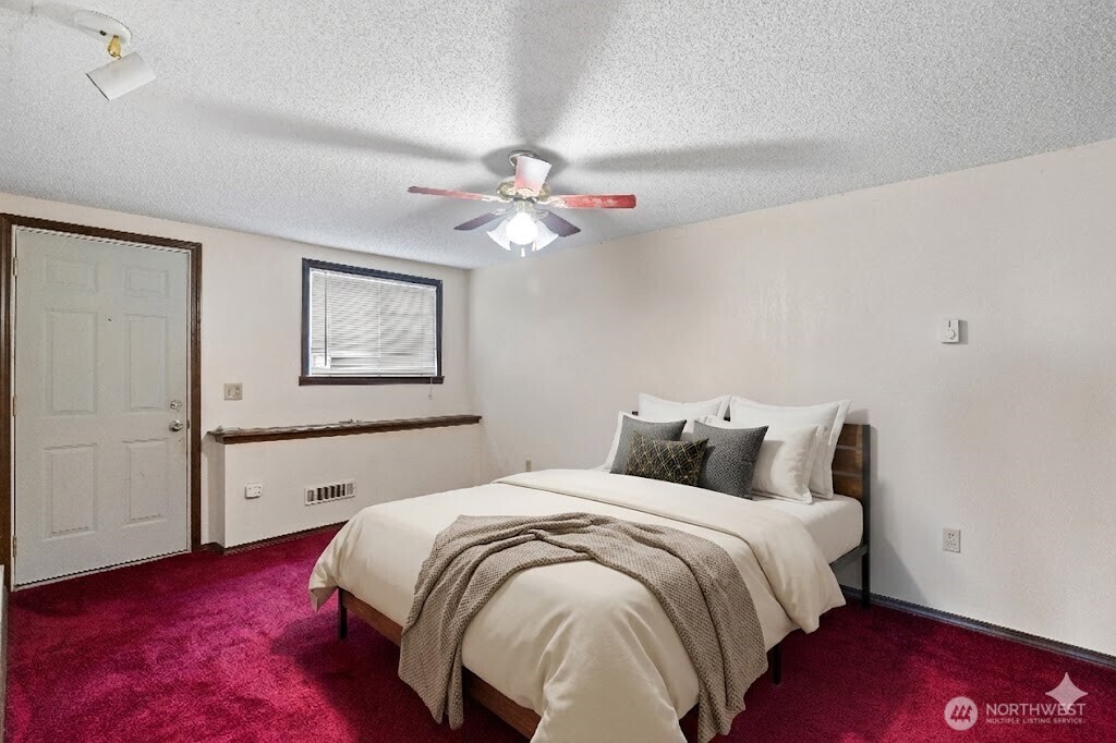2113 East Grand Avenue Everett, WA 98201 - Photo 16 of 22 a bedroom with a bed and a chandelier