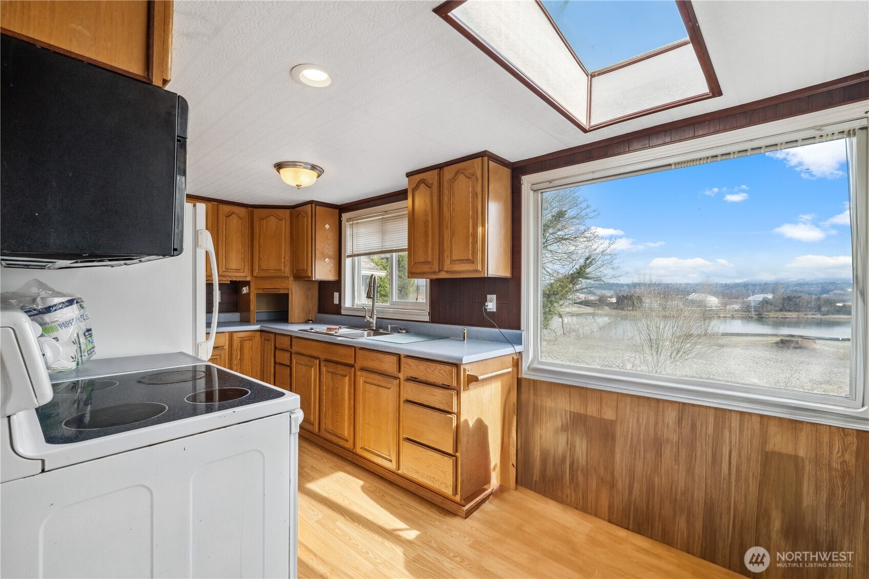 2113 East Grand Avenue Everett, WA 98201 - Photo 18 of 22 a kitchen with stainless steel appliances granite countertop a sink a stove and a refrigerator