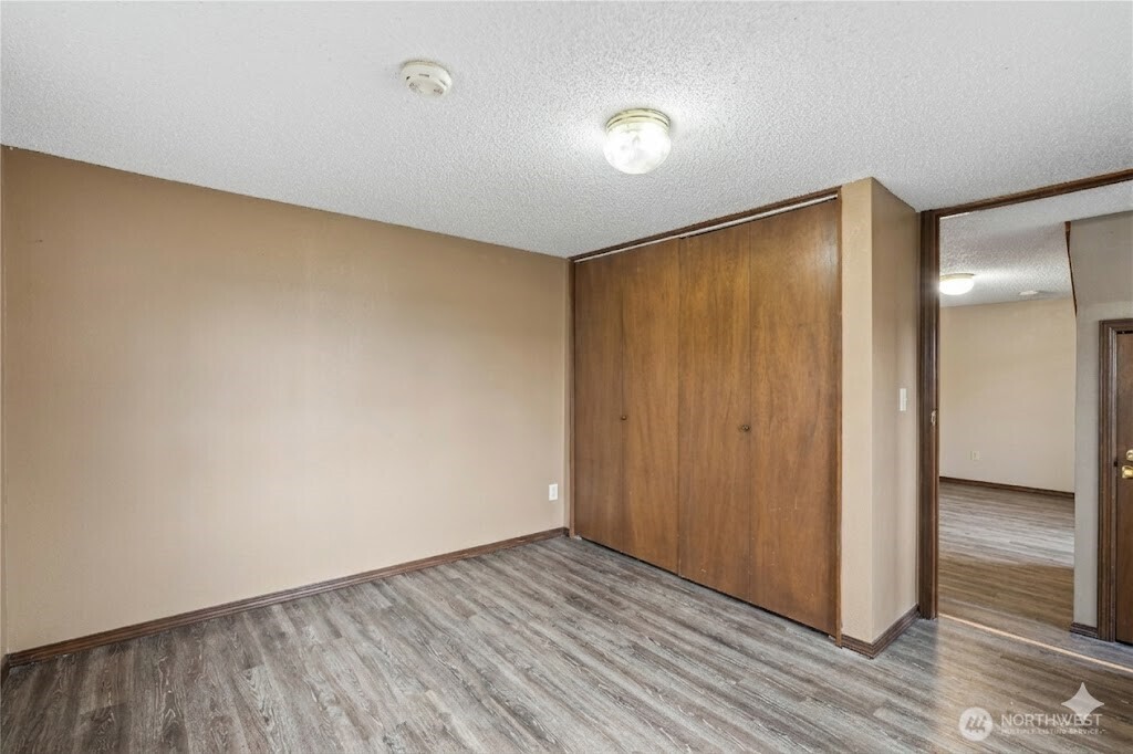 2113 East Grand Avenue Everett, WA 98201 - Photo 20 of 22 a view of an empty room with wooden floor and closet
