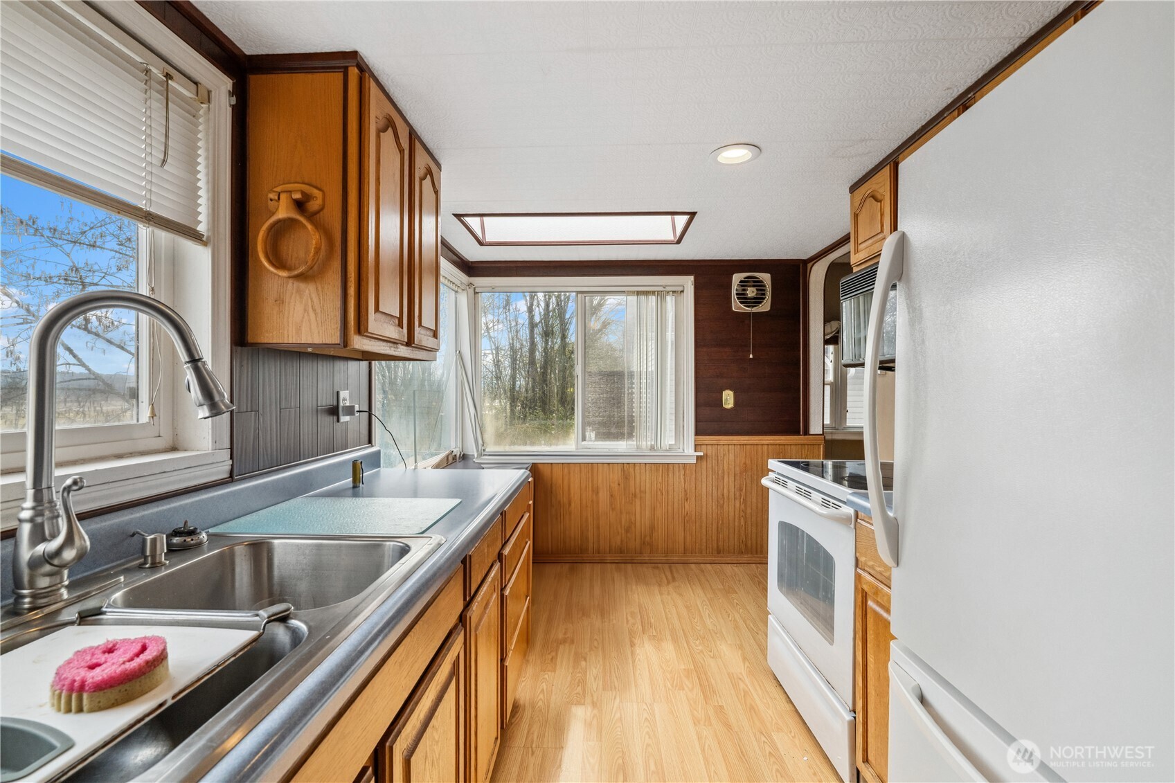 2113 East Grand Avenue Everett, WA 98201 - Photo 2 of 22 a kitchen with stainless steel appliances granite countertop a sink a stove and a refrigerator