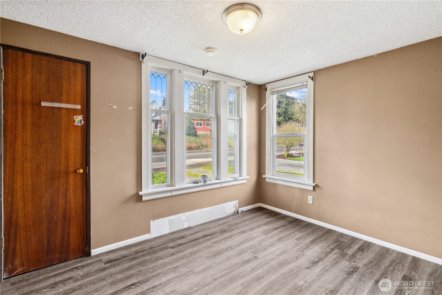 2113 East Grand Avenue Everett, WA 98201 - Photo 10 of 22 an empty room with wooden floor and windows