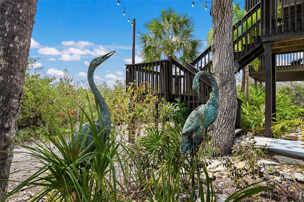 7325 Holly Road Terra Ceia, FL 34250 - Photo 73 of 87 a front view of a house with a yard and fountain in middle
