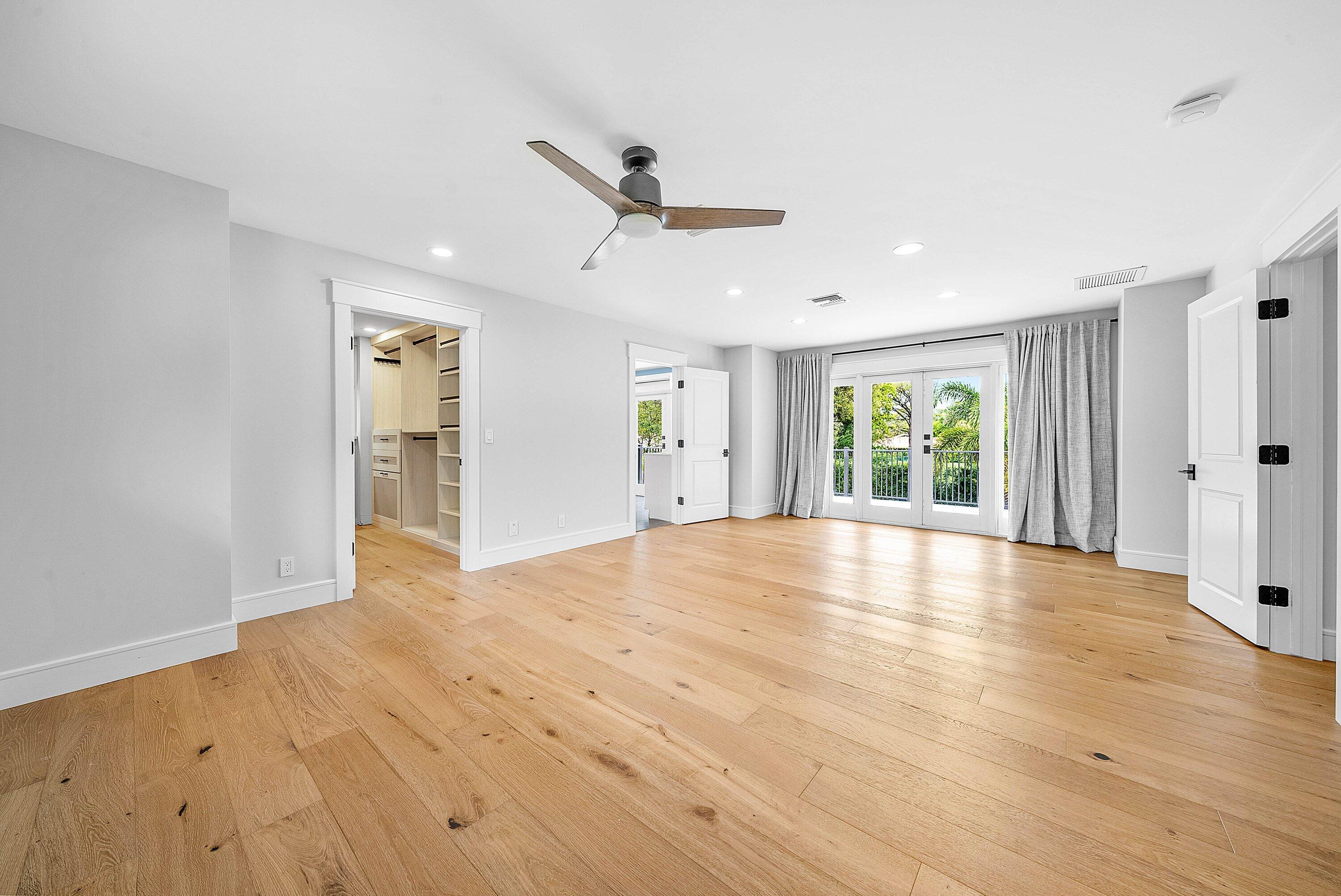 10893 Gleneagles Road Boynton Beach, FL 33436 - Photo 11 of 134 a view of empty room with wooden floor and fan