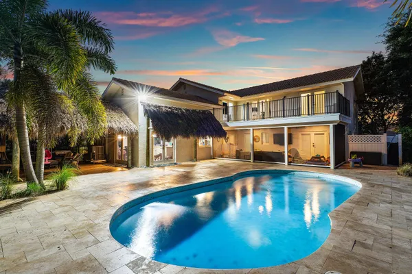 an aerial view of residential houses with outdoor space and swimming pool